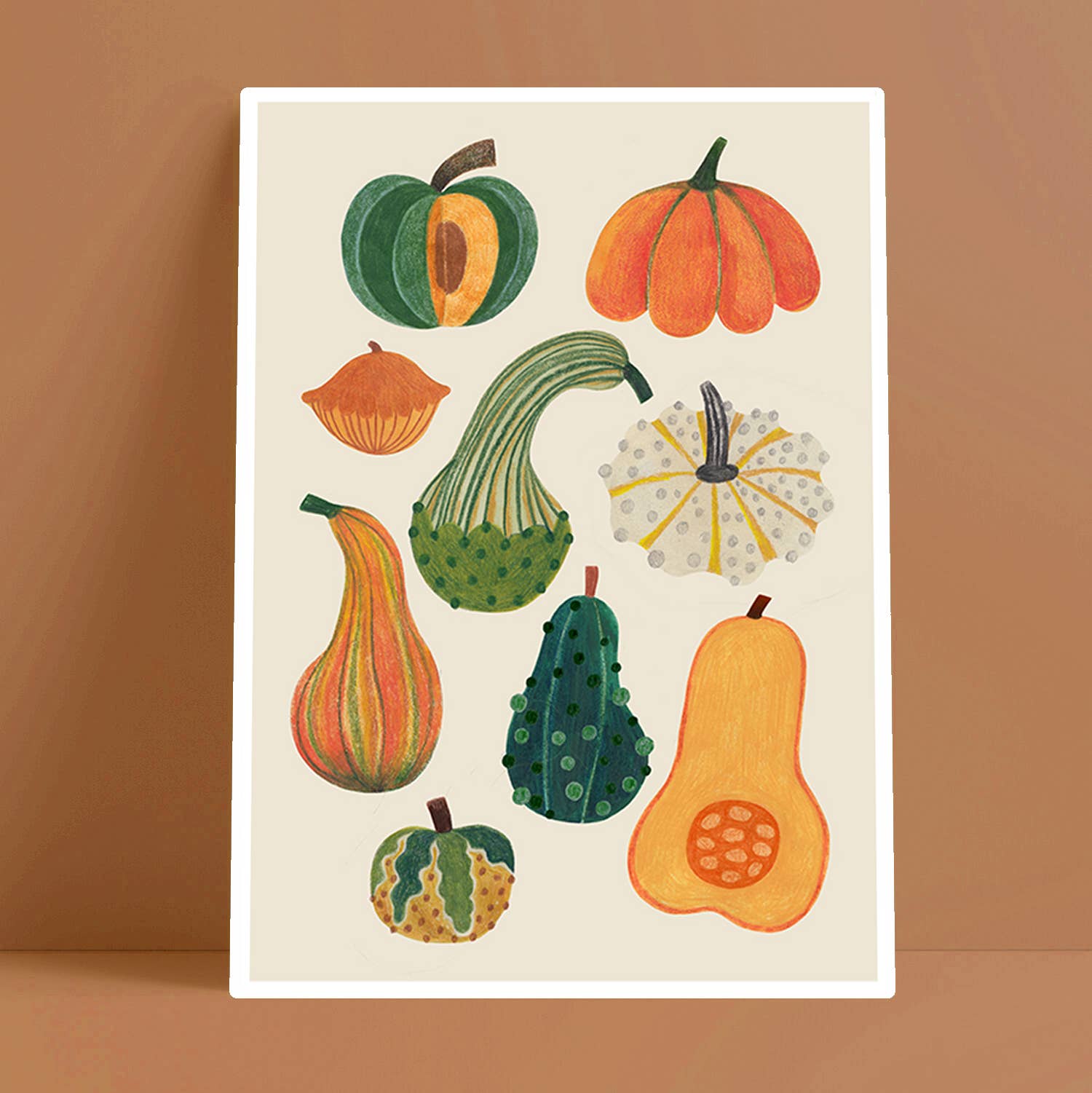 Illustration of various pumpkins on a beige background with a brown border.