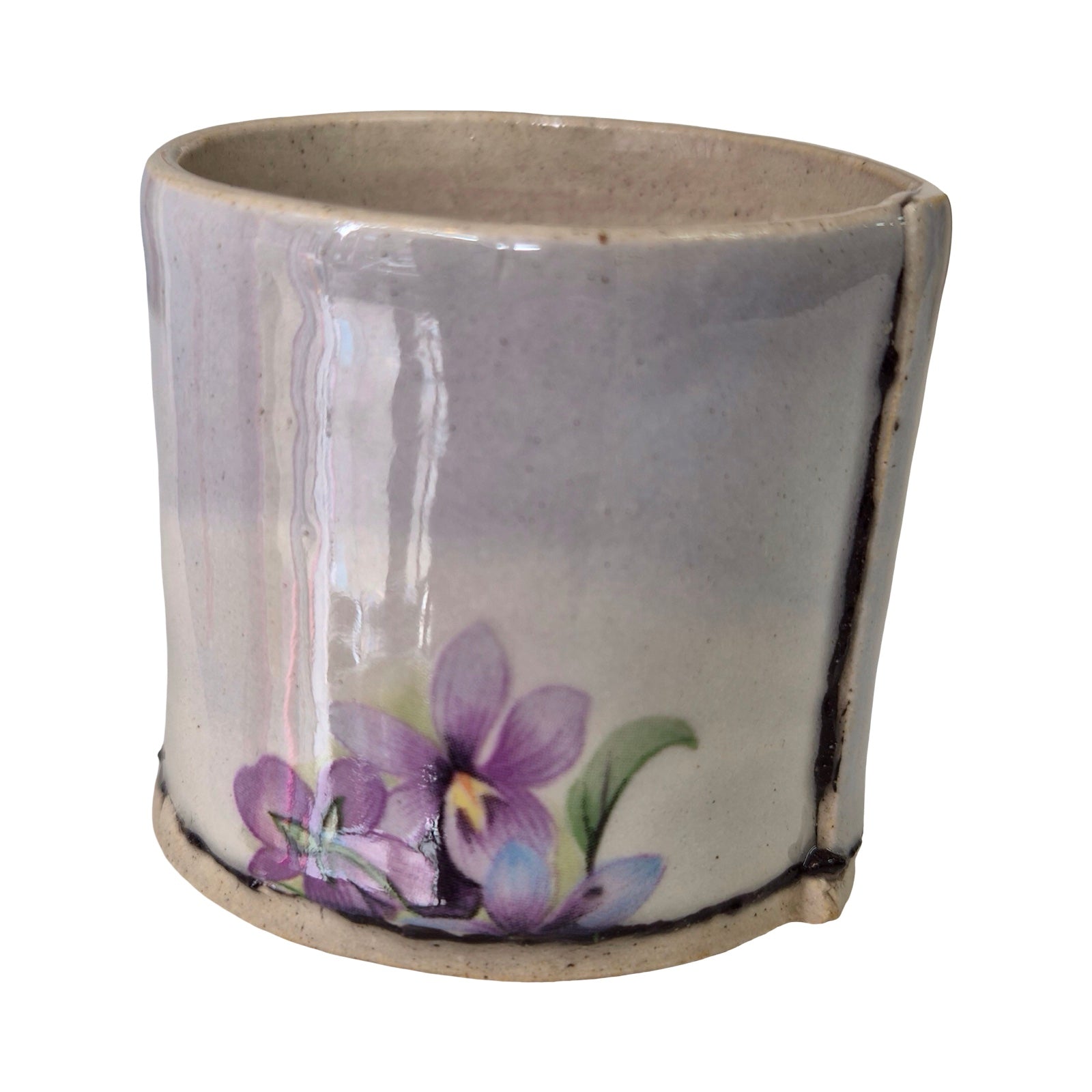 Ceramic planter with purple floral design on a white background.