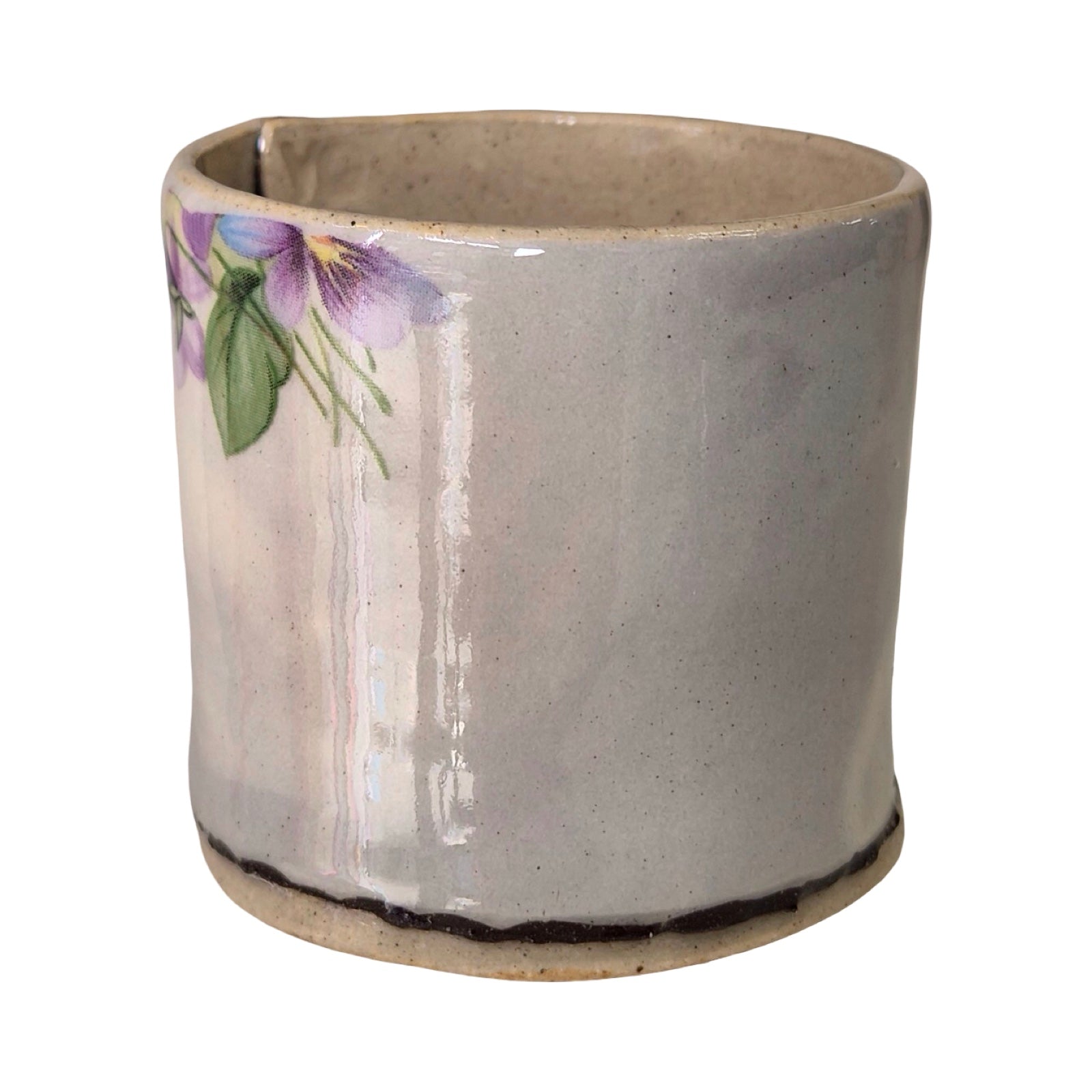 Ceramic planter with floral design on a white background.
