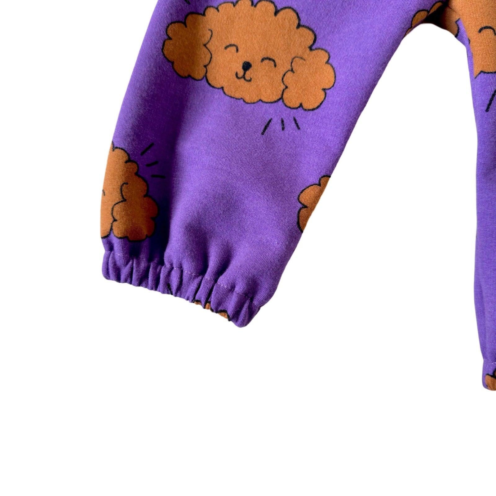 Purple baby joggers with a poodle pattern, featuring elastic waistband and cuffs.