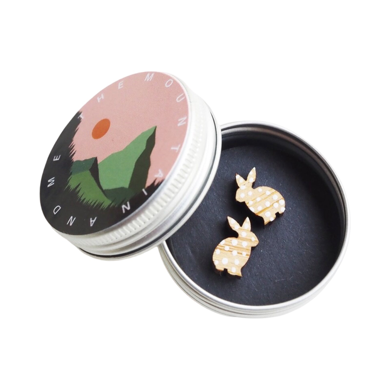 Rabbit-shaped stud earrings with white spots in a small metal tin.