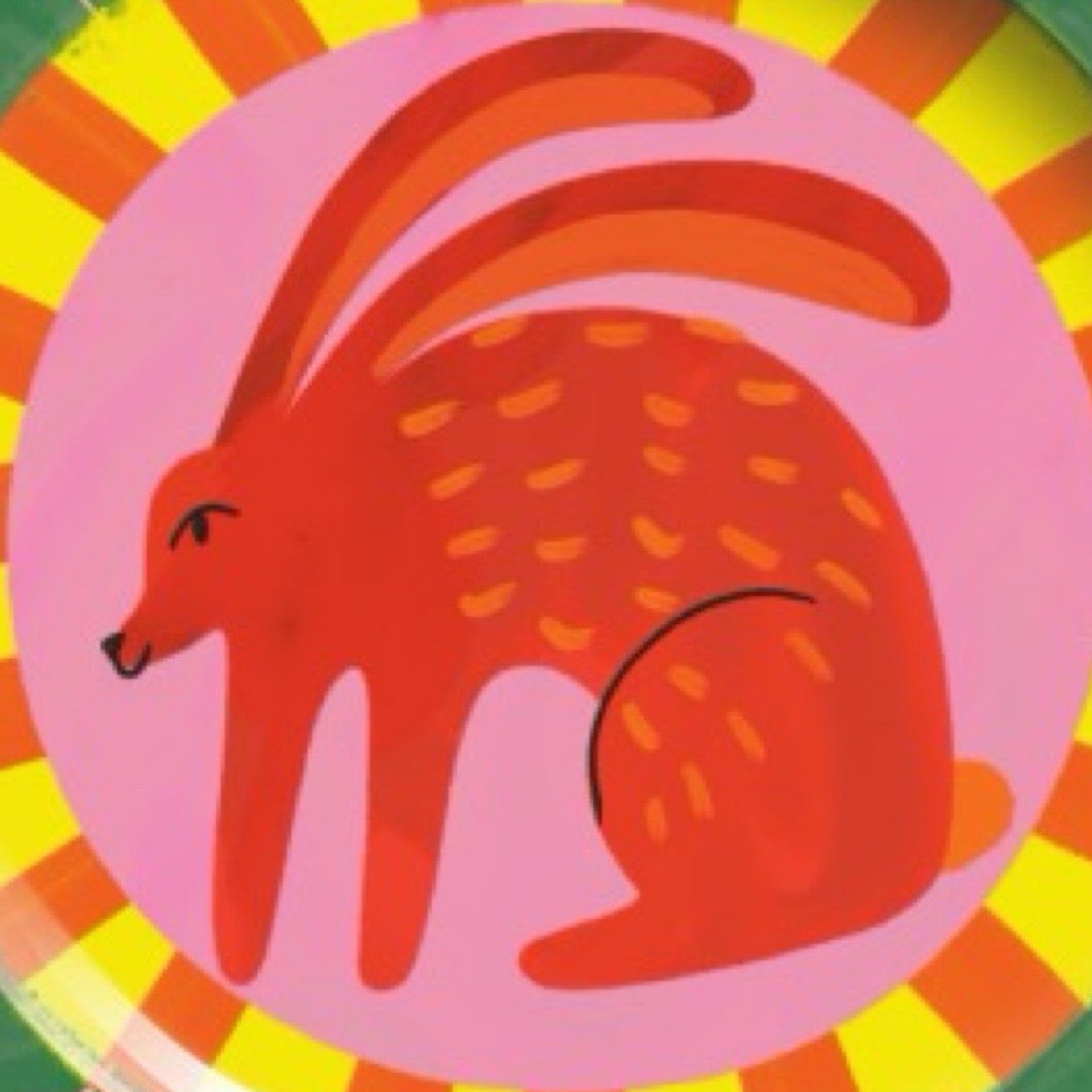 Colourful children's plate with a red rabbit design on a multicoloured background.