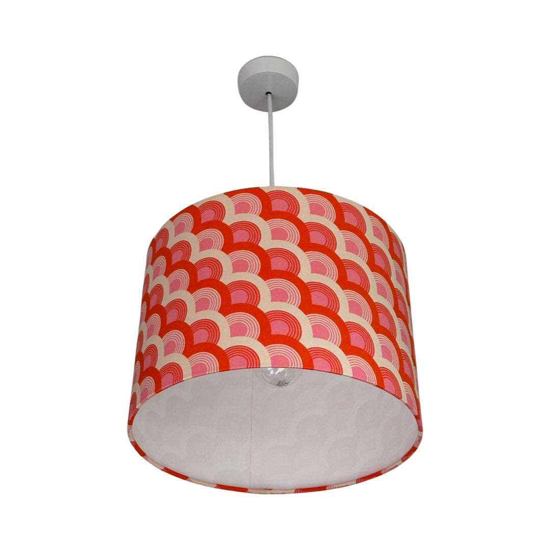 Drum lampshade covered in red, pink and white rainbows