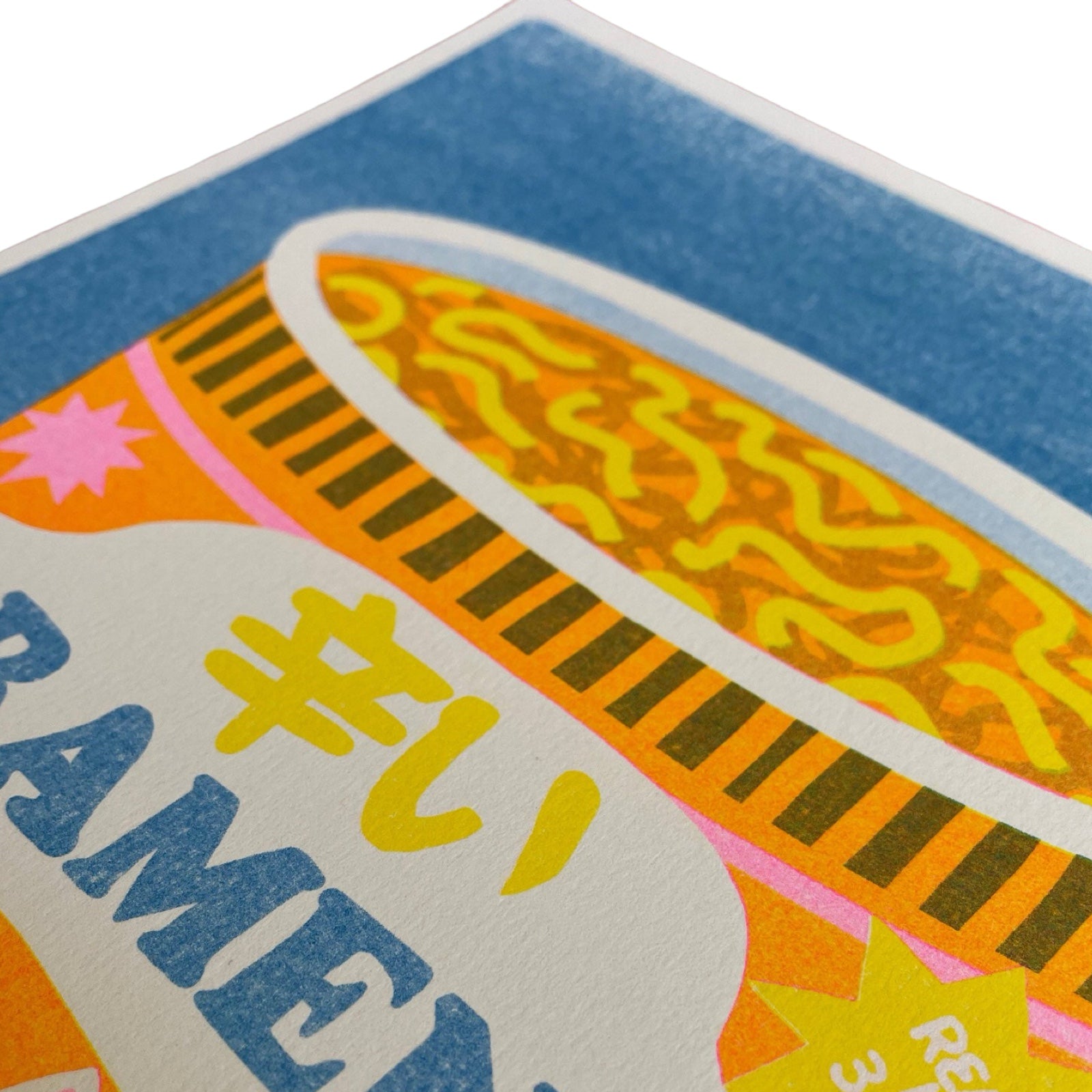 This colourful risograph print features a tub of ramen noodles against a blue background.