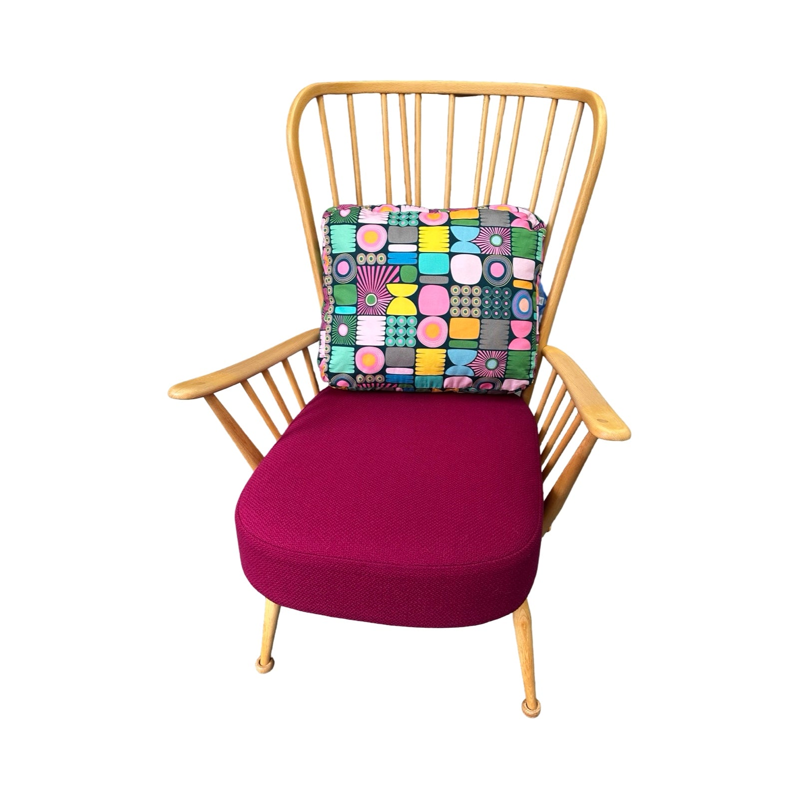 Chair with a colorful geometric cushion on a white background