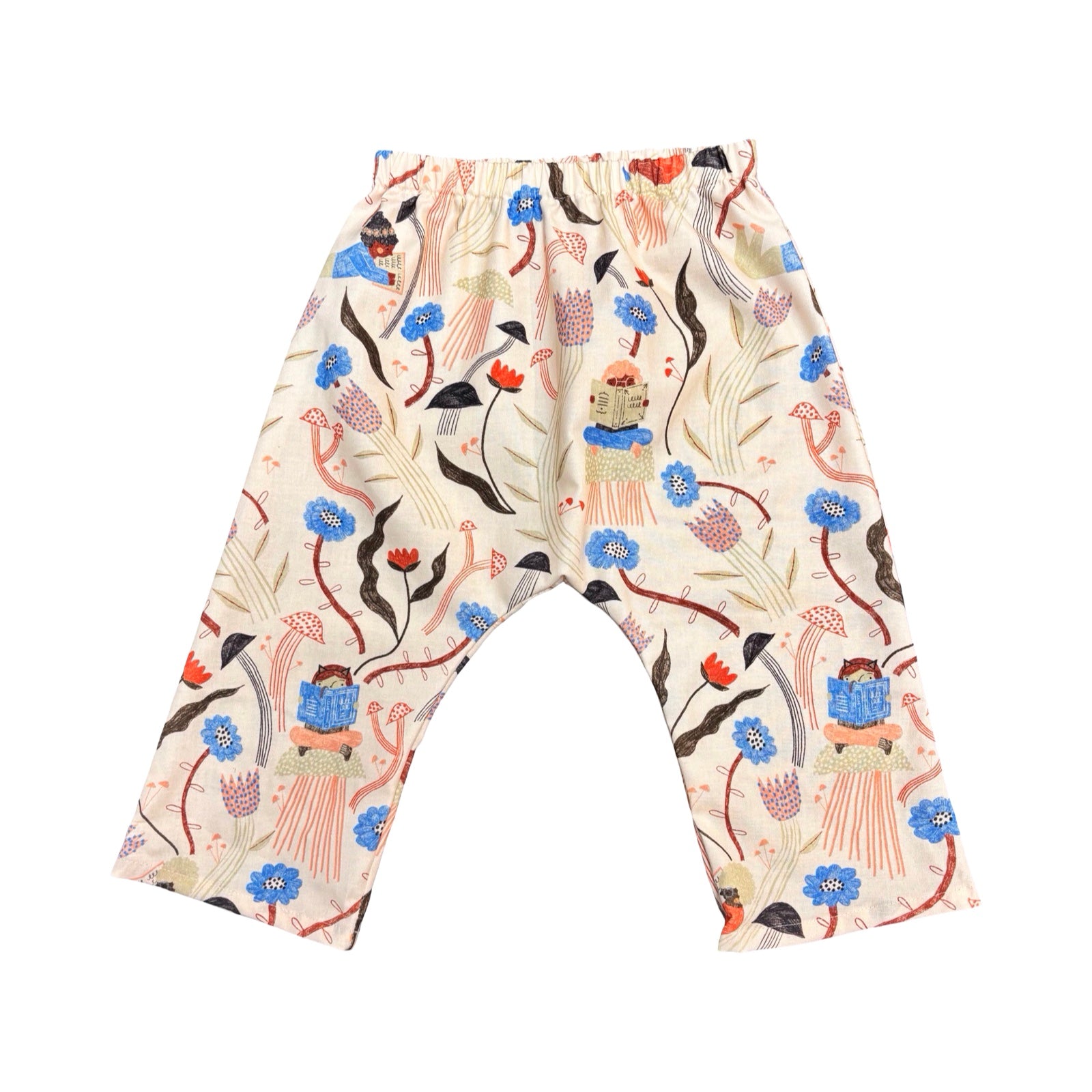 Colourful children's pants with floral and reading pattern on a white background.