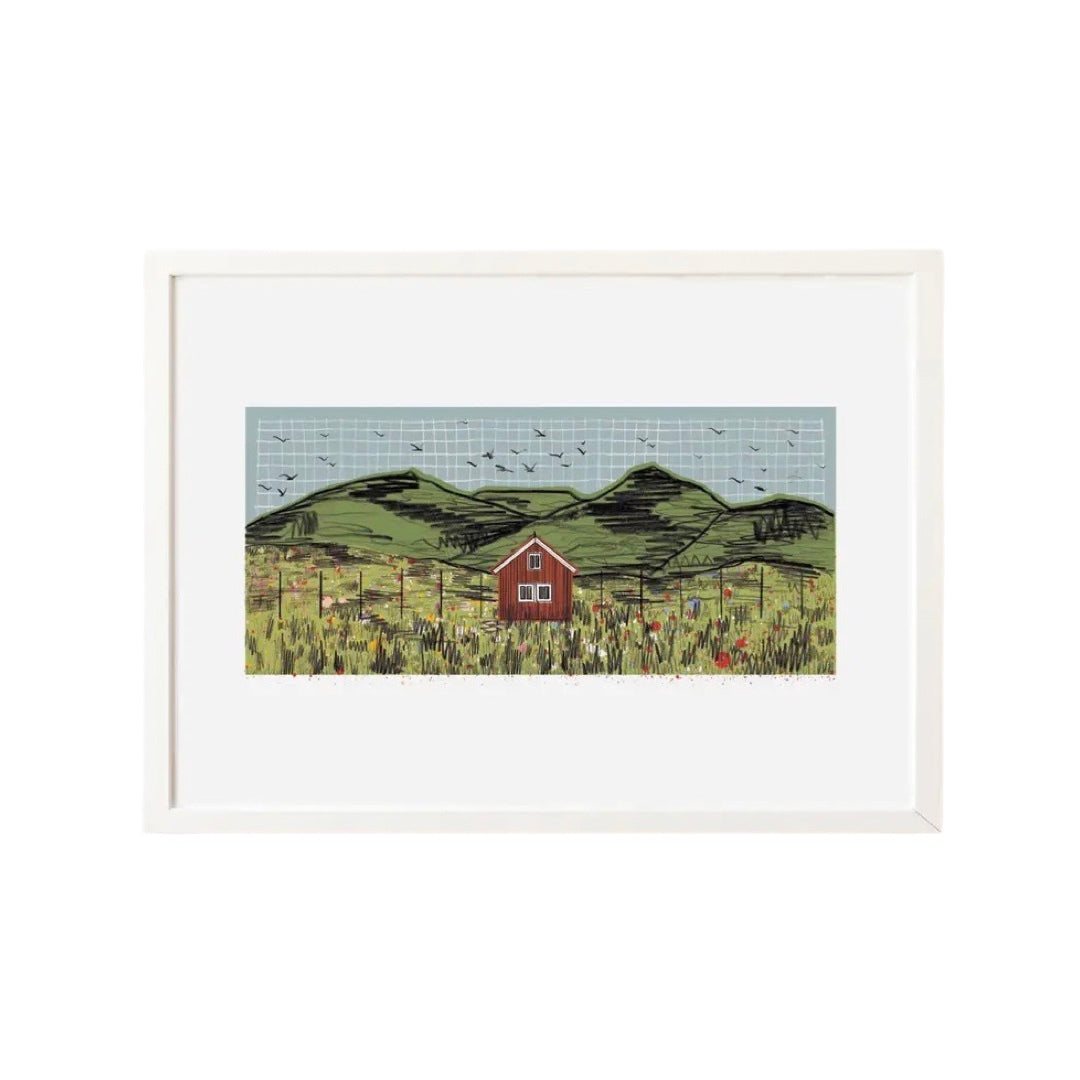 A3 calming print of a red cabin nestled in a fence line in a meadow in the foreground and birds circling above the hills overhead