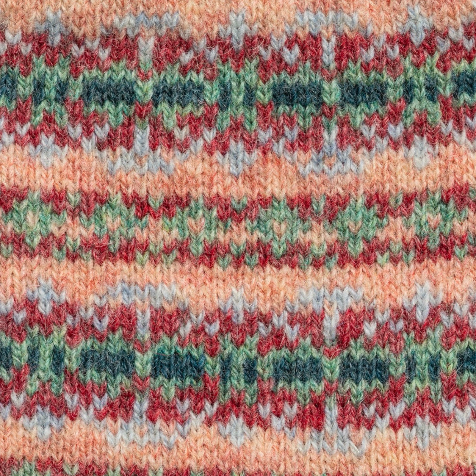 Close-up of a knitted fabric with a multicolor pattern.
