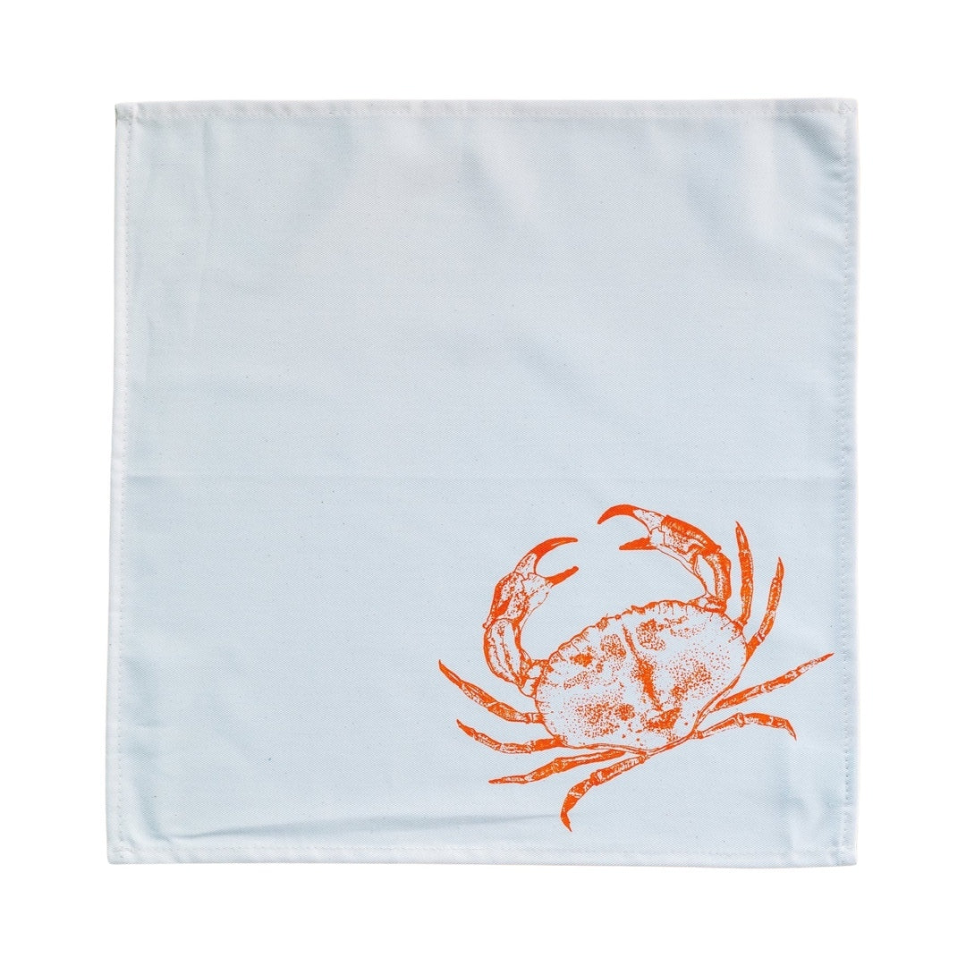 Rolled cream cotton napkin with a red crab design.