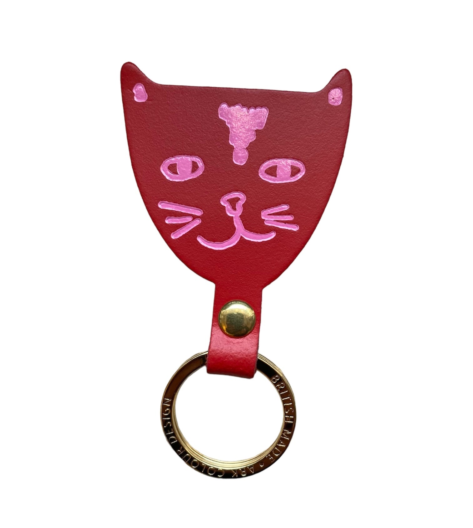 A red leather cat head-shaped keyring with pink facial details and a gold ring.