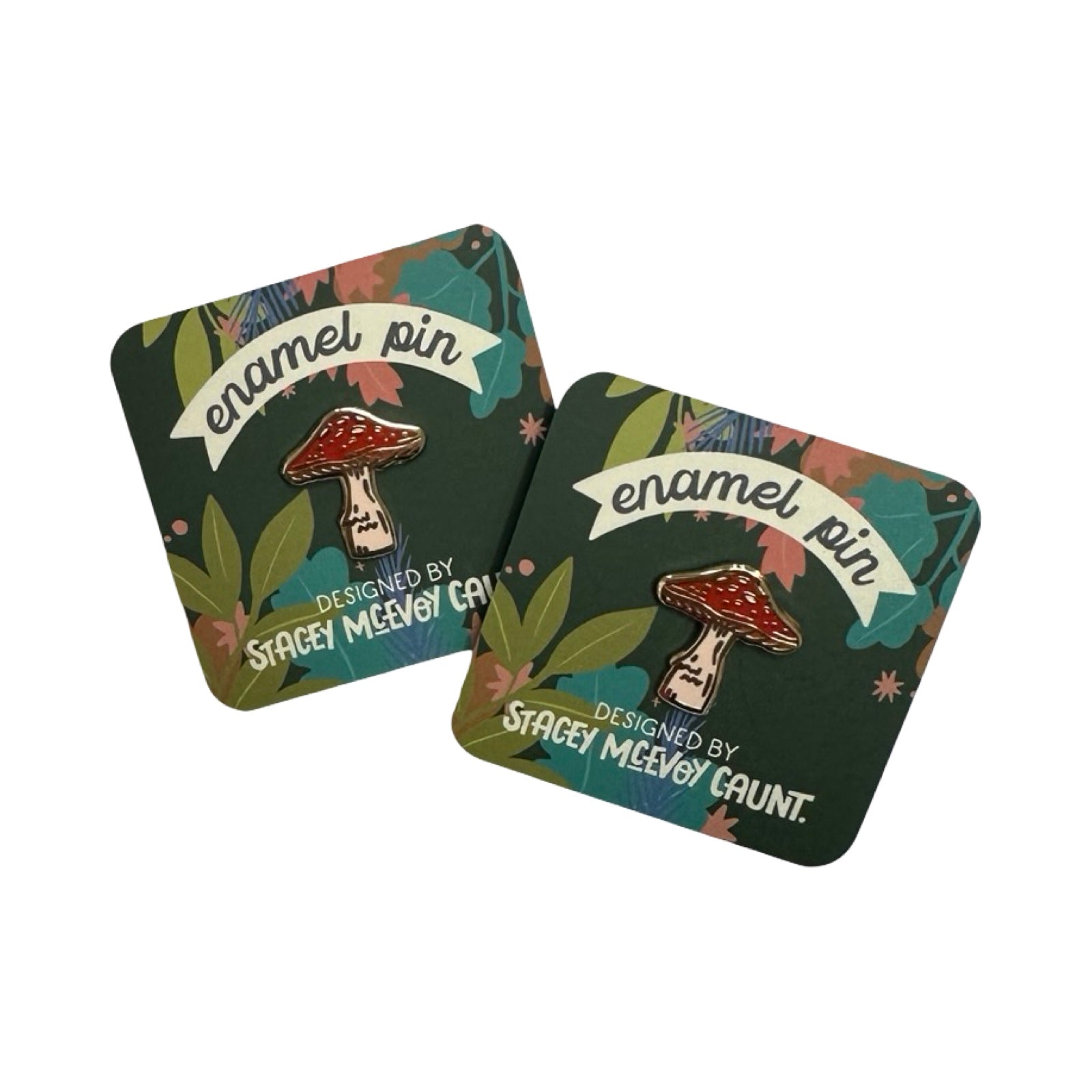 Two enamel pins with mushroom design on a decorative cards.
