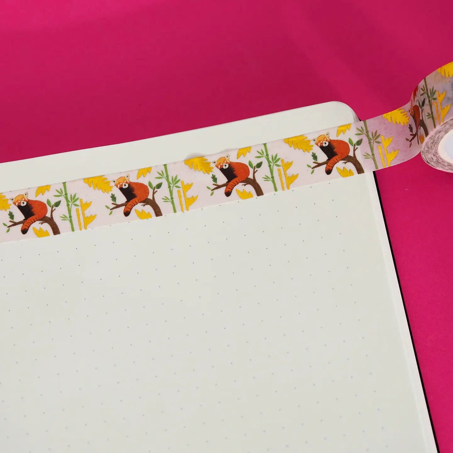 Decorative washi tape with monkey design on a pink background.