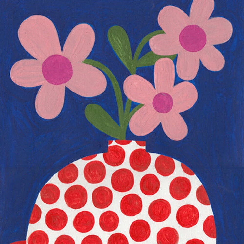 Red polka dot vase with pink flowers on a blue background.