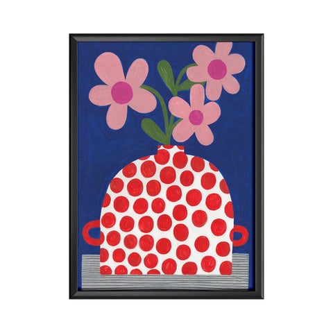 This art print features a beautiful red polka dot vase with pink flowers against a blue background.