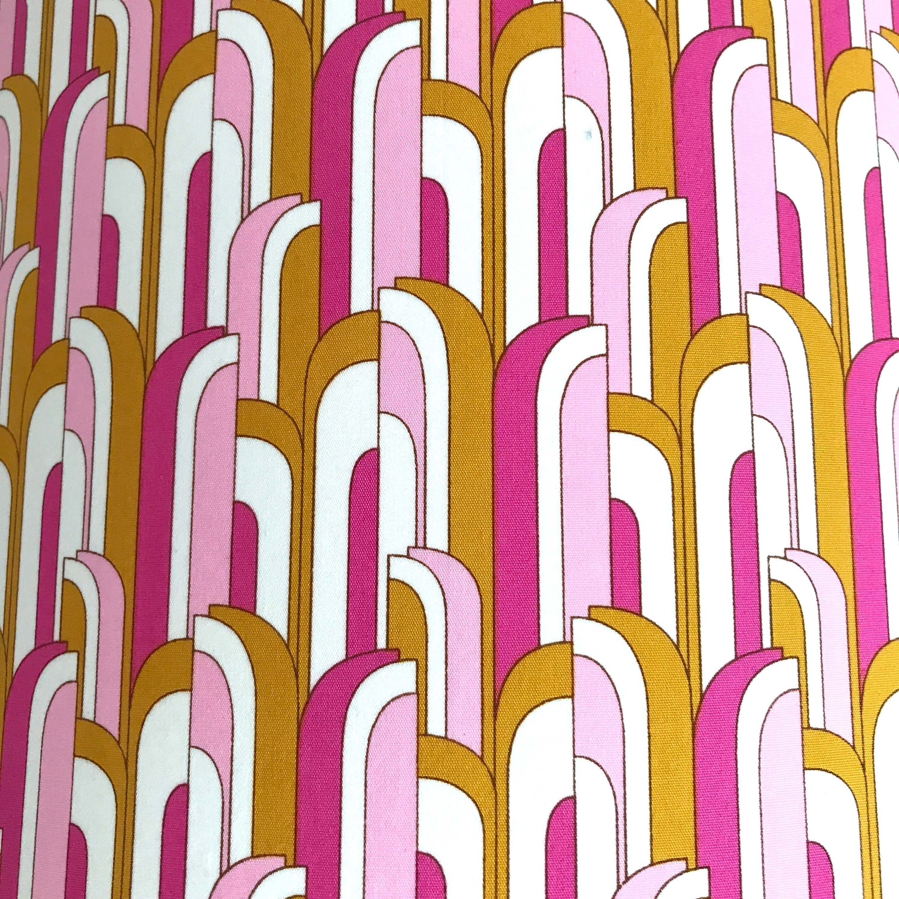 Fabric in a pink, white and mustard mid-century-inspired retro arch design