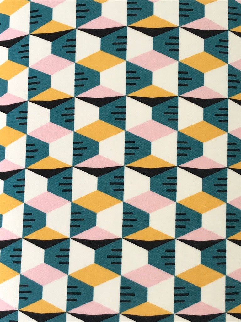 Cotton fabric with a mustard, pink, white and blue geometric pattern.