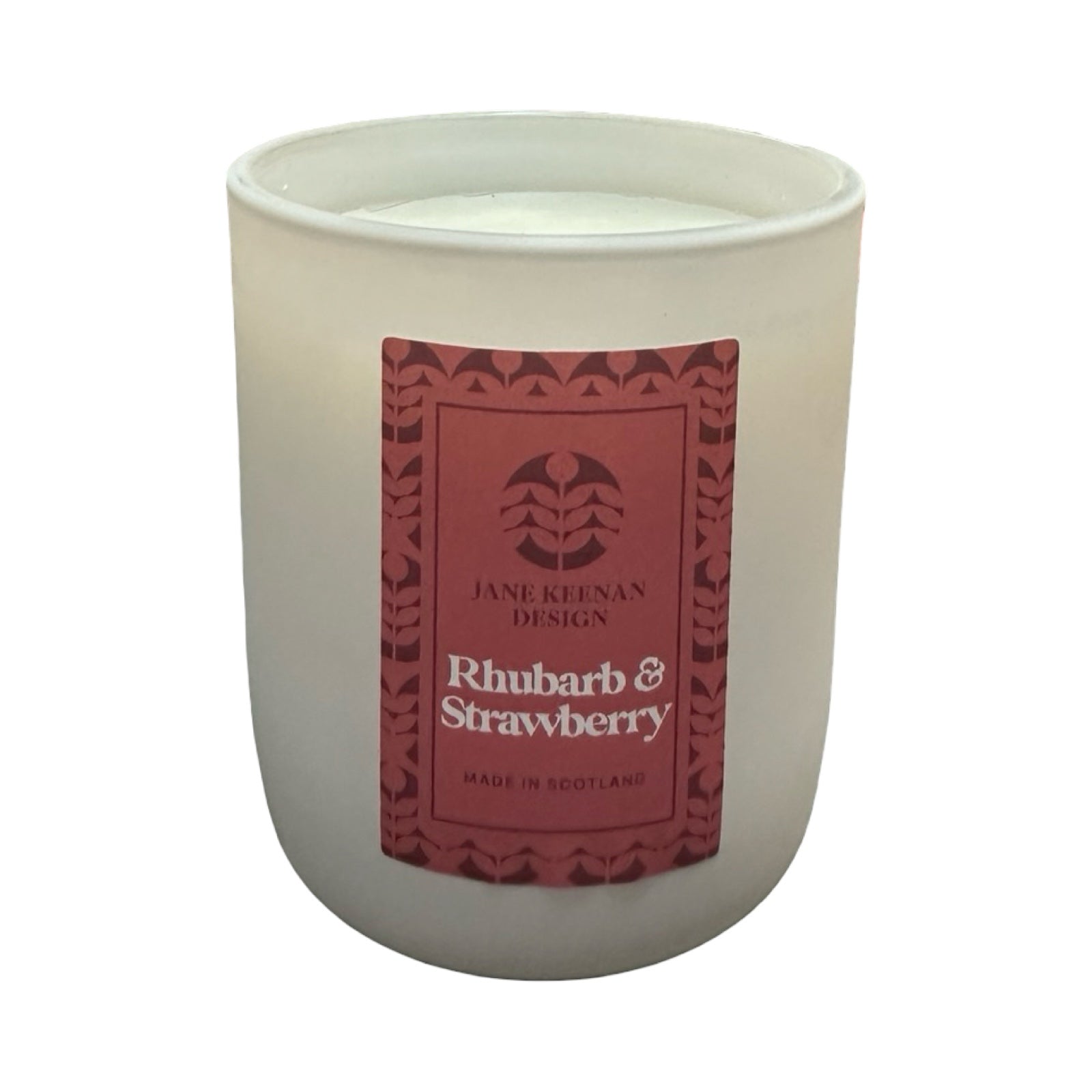 Candle in a white container with a red label featuring 'Jane Keenan Design' on a white background.