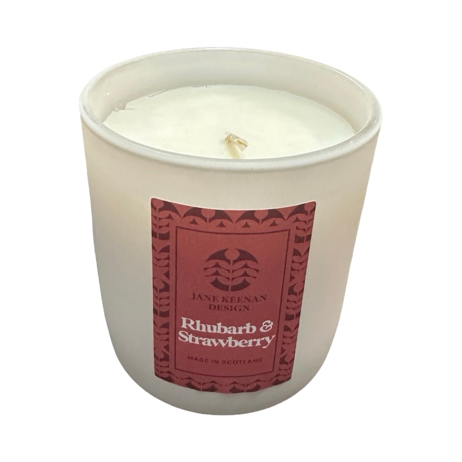 Candle in a white container with a red label on a white background.