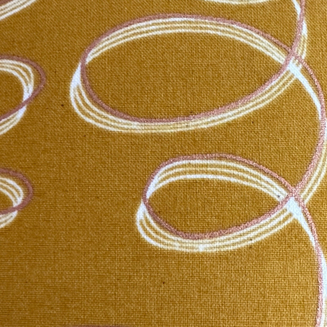 Mustard cotton fabric with white and gold ribbons.