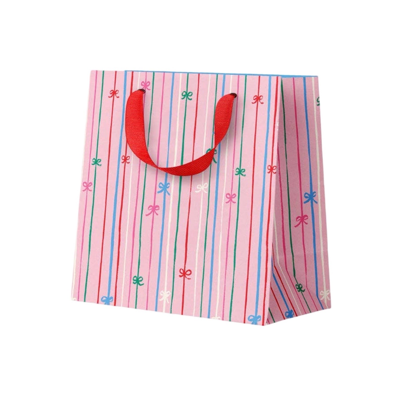 A pink gift bag with vertical red, green, and blue stripes, decorated with small bow motifs, and featuring red ribbon handles.