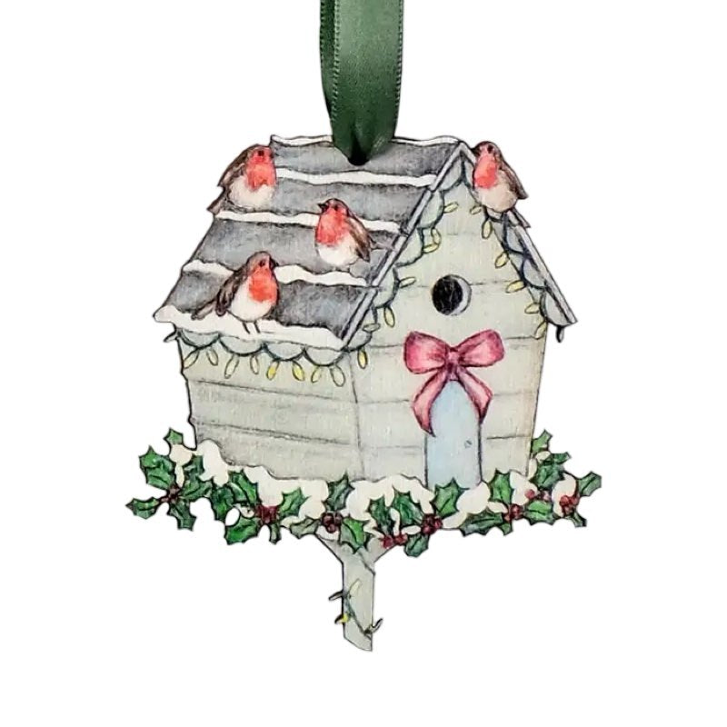 Wooden Christmas decoration of a bird house sitting on a holly wreath with robins perched on the roof. 