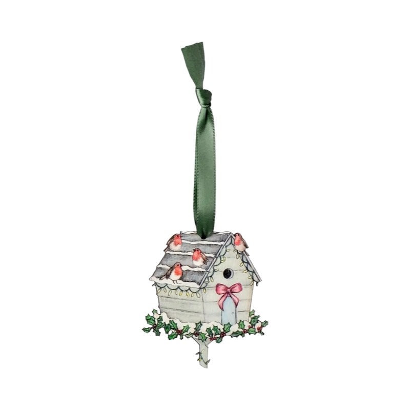 Wooden Christmas decoration of a bird house sitting on a holly wreath with robins perched on the roof. 