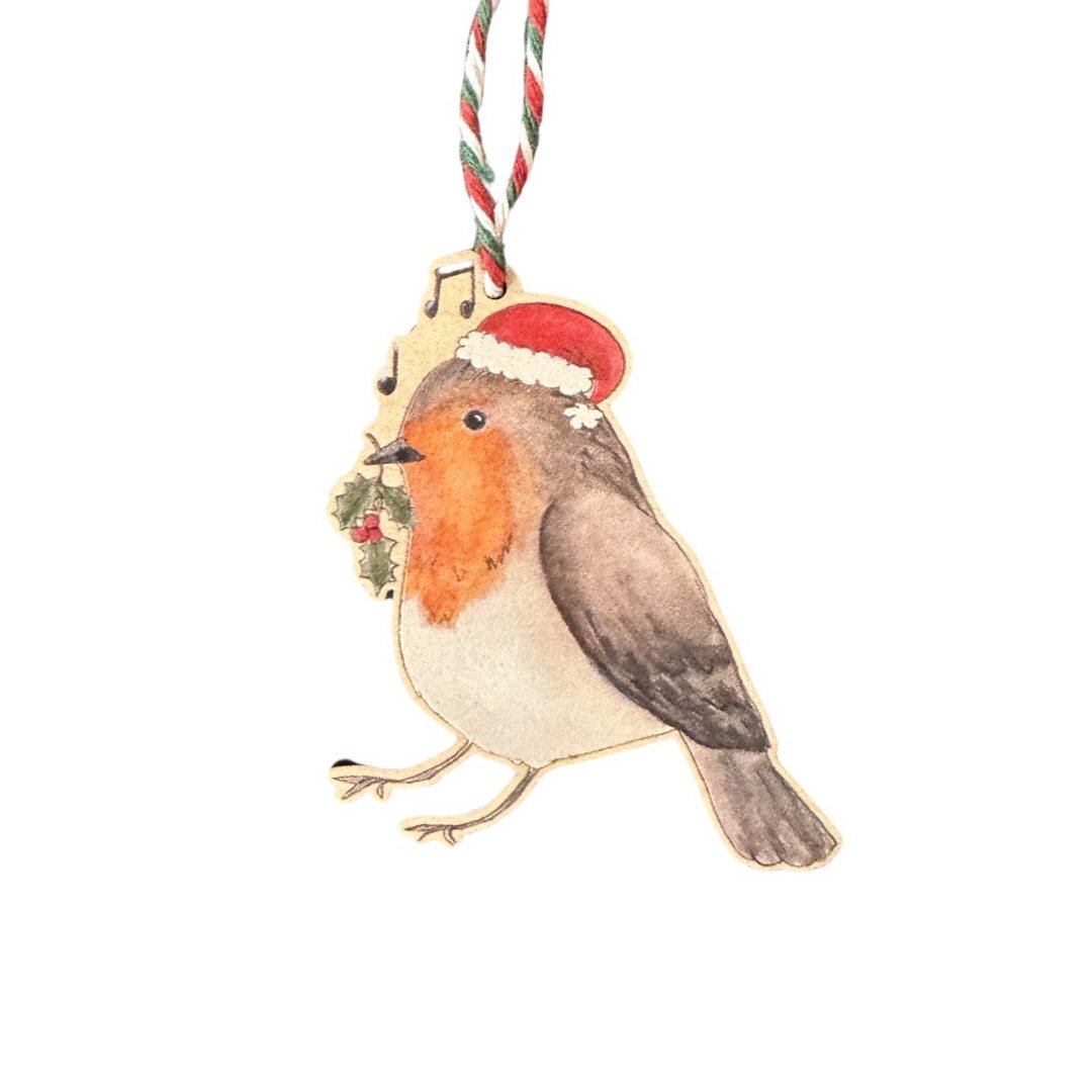 Christmas decoration of a robin wearing a Santa hat and holding a stem of holly in its beak.
