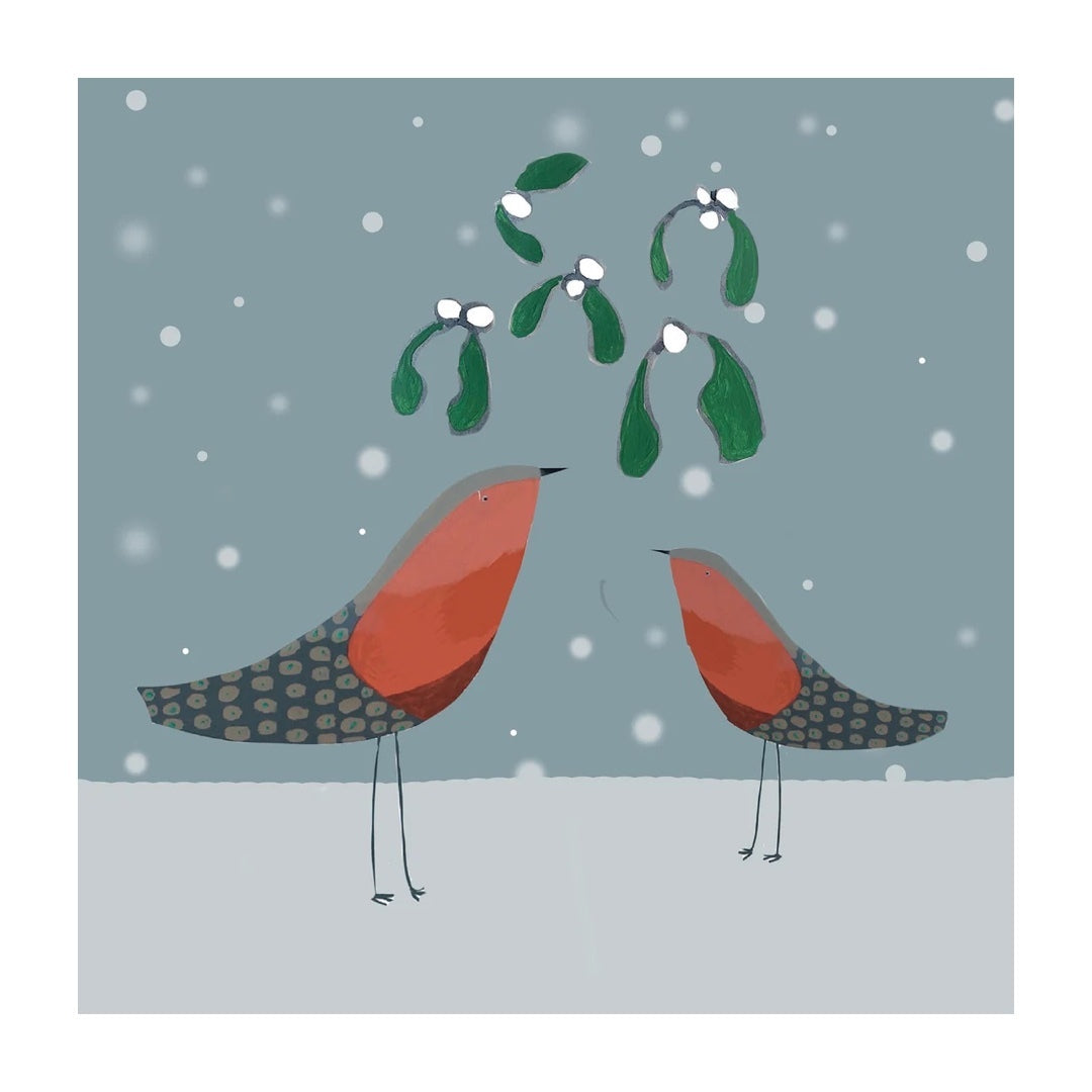 Christmas card featuring an illustration of a two red breasted robins under a bunch of mistletoe on a blue snowy background. 