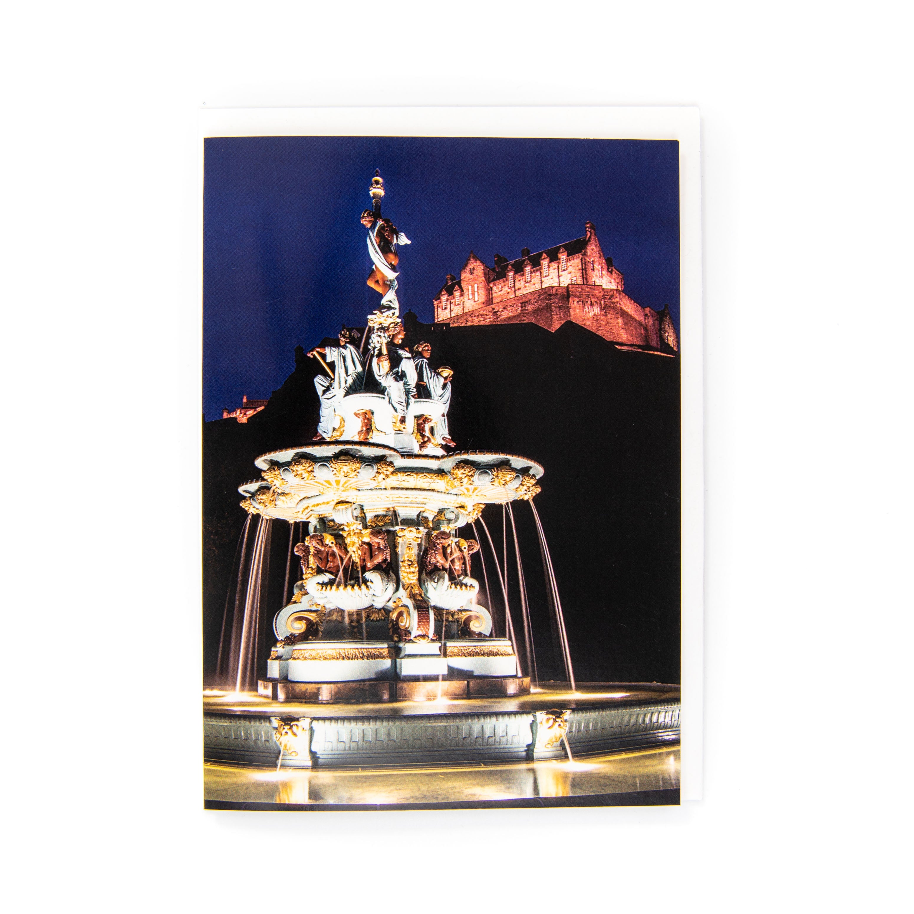 An image of the Ross Fountain and Edinburgh Castle at night on a card. 