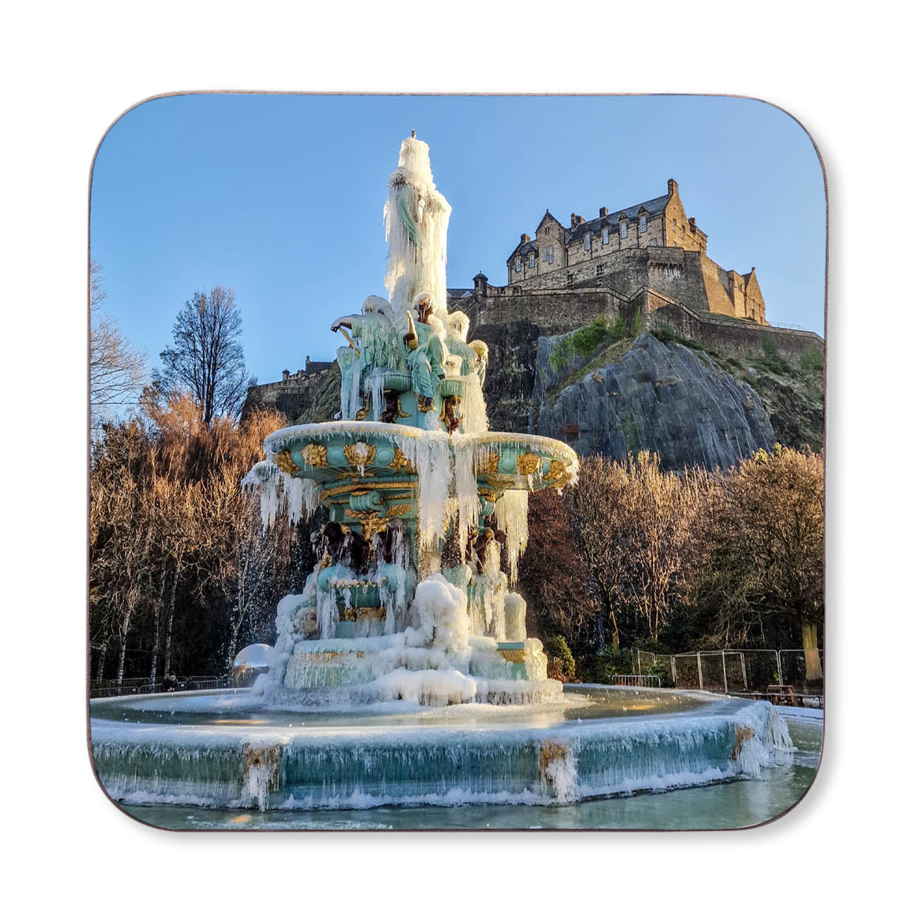 A pciture of the Ross Fountain frozen with Edinburgh Castle in the background.