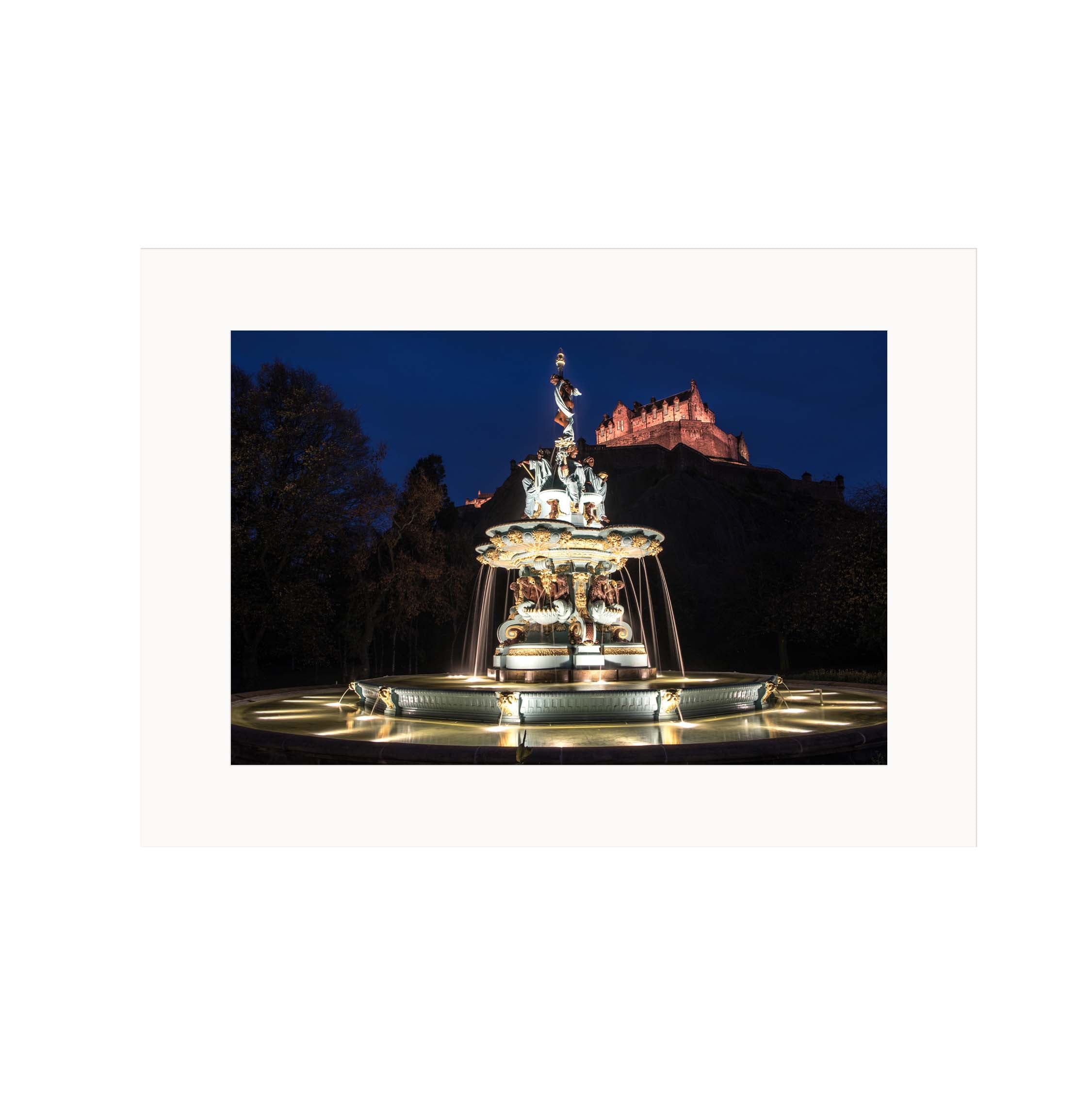 An image of the Ross Fountain at night against the backdrop of Edinburgh Castle in a mount. 