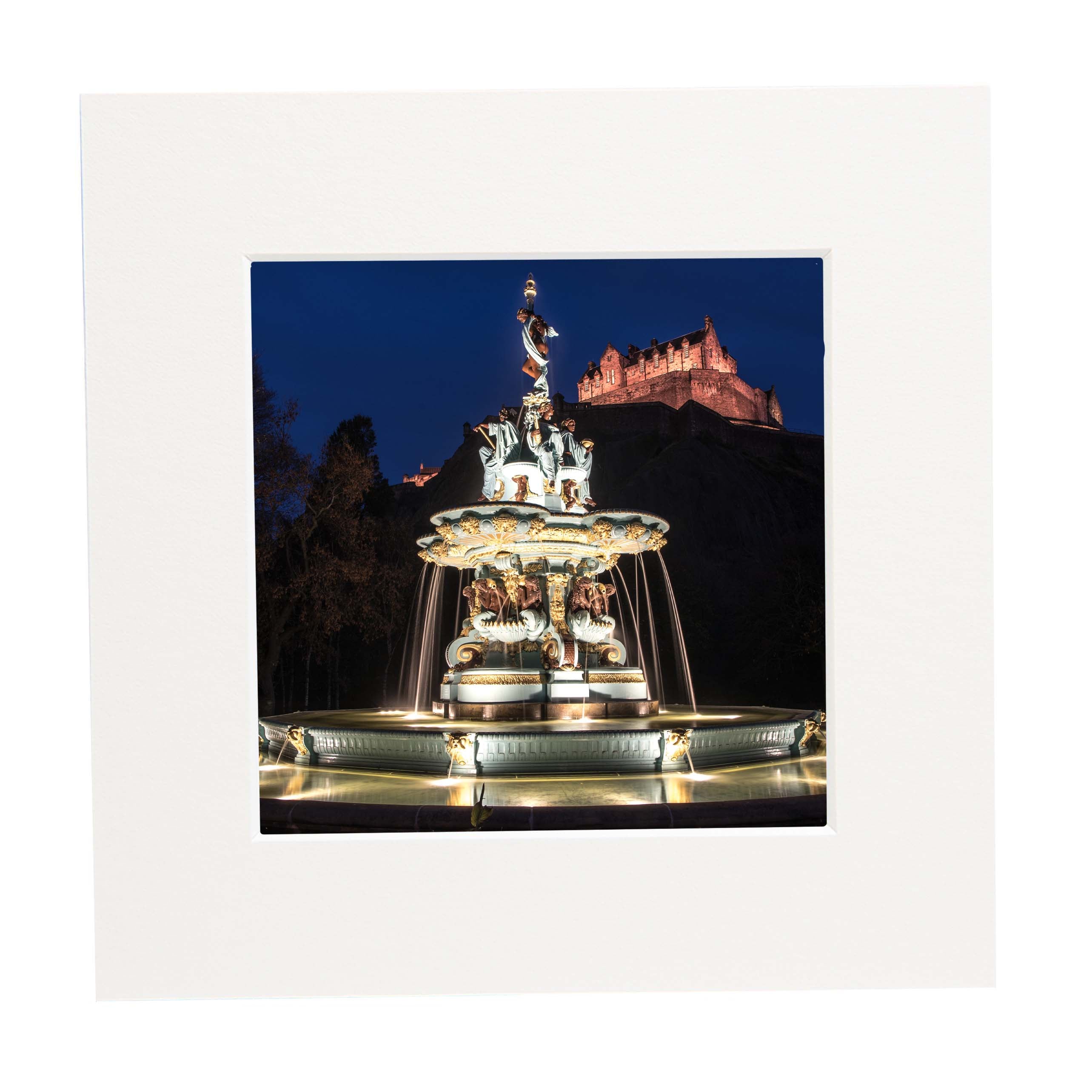 An image of the Ross Fountain at night with Edinburgh Castle in the background in a square mount. 