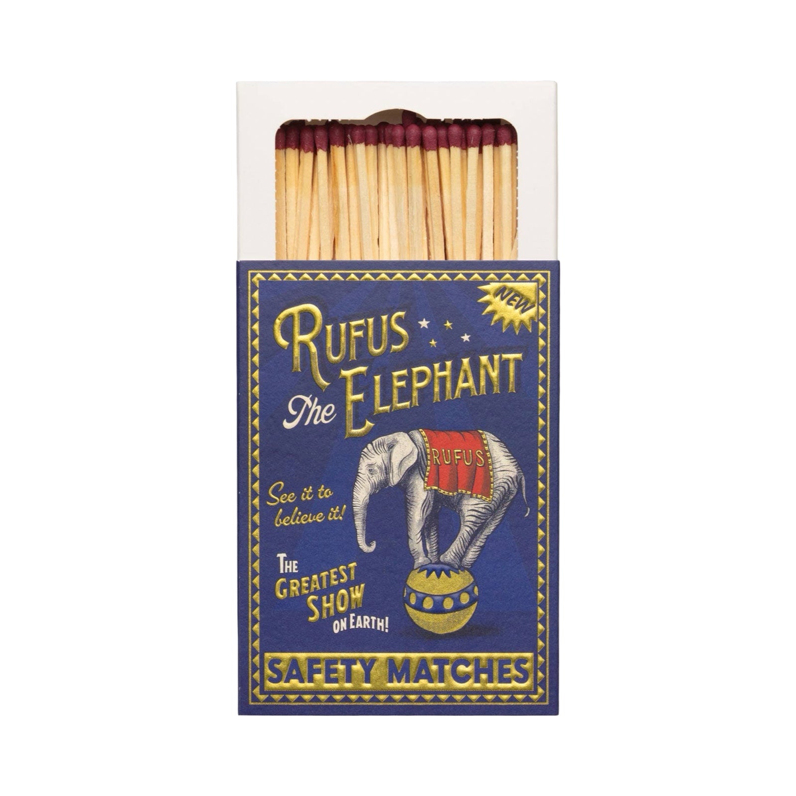 A vintage-style matchbox package labeled 'Rufus the Elephant' with safety matches visible inside. The box is dark blue with gold and white lettering, an elephant circus illustration, and a small yellow burst reading 'NEW'.