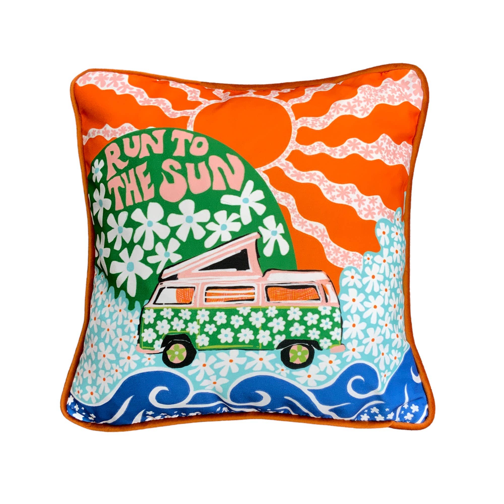 Colourful cushion featuring a green and pink campervan with white flowers in a field full of daisies and a bright orange sun. The cushion is trimmed with handmade velvet piping and backed with luxurious royal blue velvet.