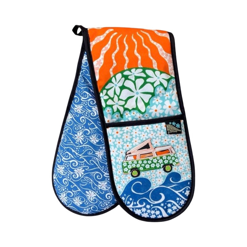 Colourful oven gloves with a pink campervan covered in green daisies against a background of blue daisies.