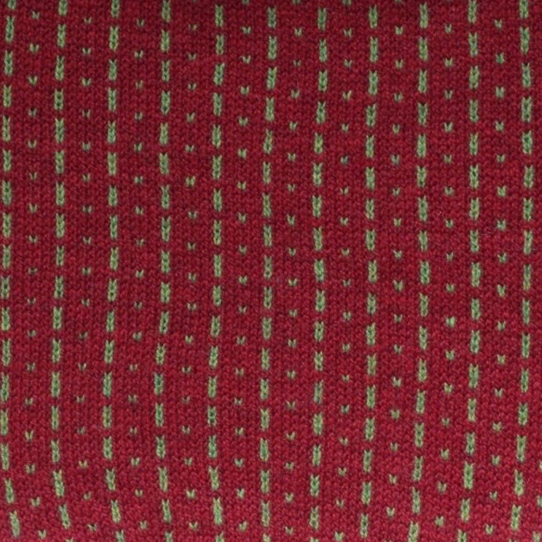 A cosy 100% lambswool knitted snood in russet red with green dashes.