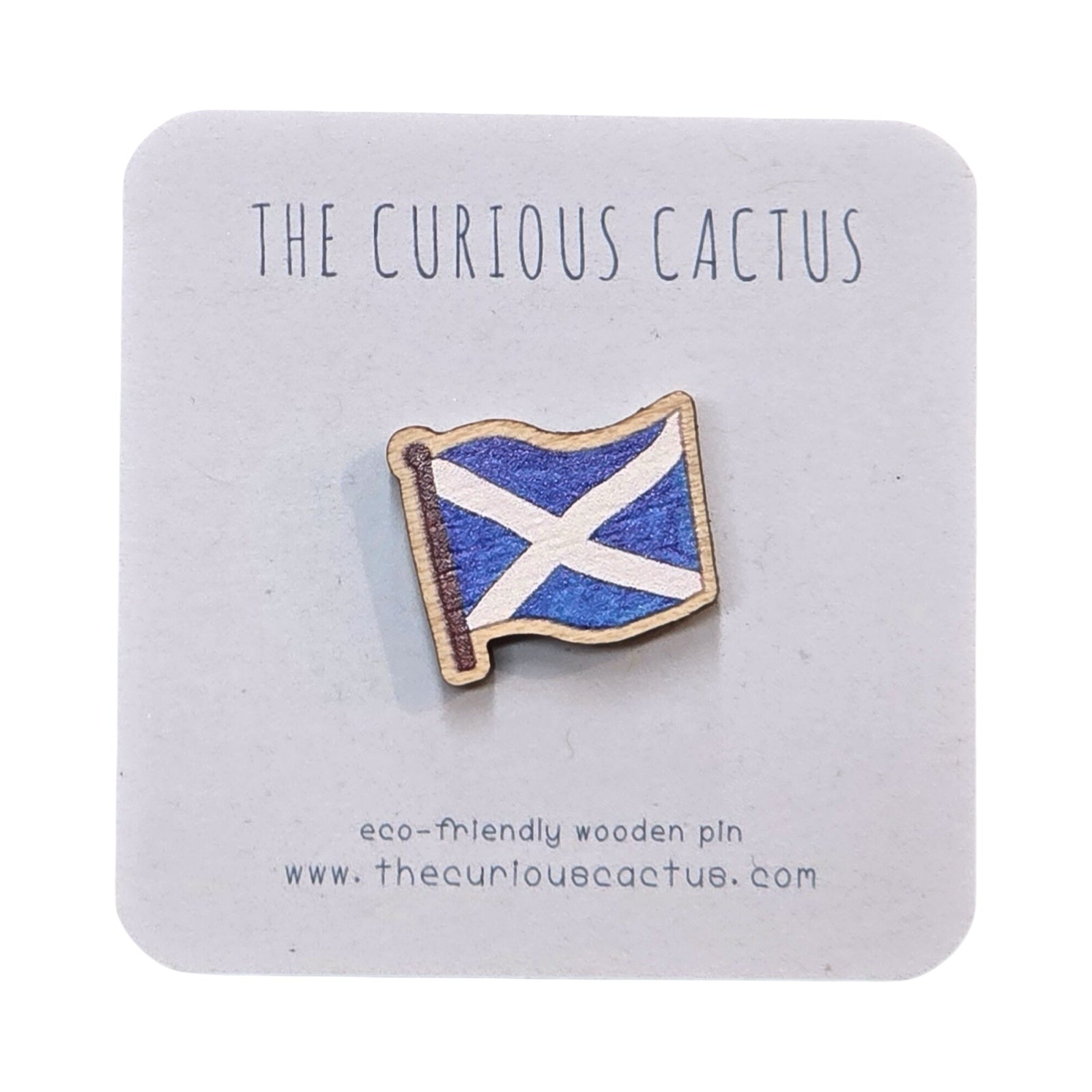 A mini wooden pin badge of the Scottish saltire flag on backing card.