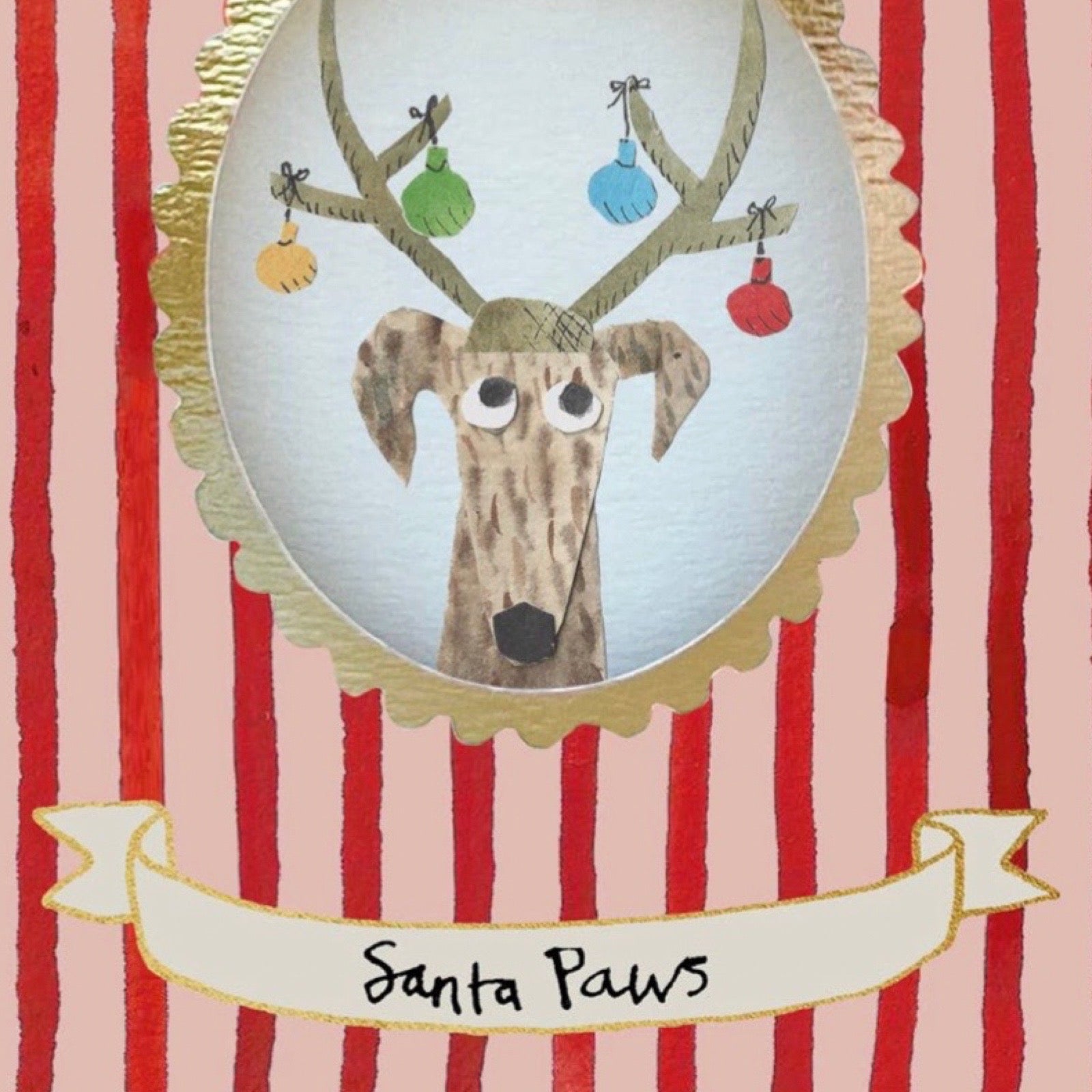 A festive illustrated card or print featuring a dog with antlers labeled 'Santa Paws' on a cream ribbon banner, set against red and white vertical stripes with a gold scalloped oval frame around the dog illustration.