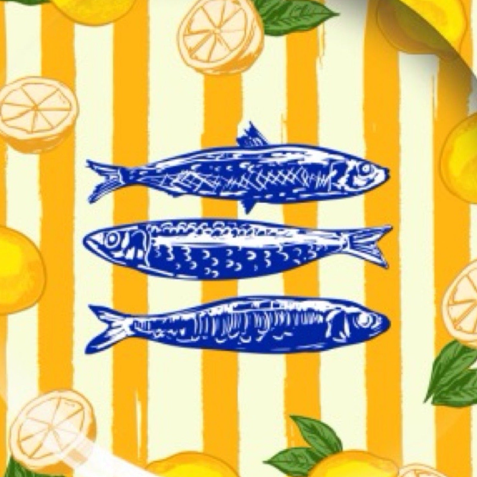 Decorative plate with yellow and white striped pattern, blue fish, and lemons on a white background.