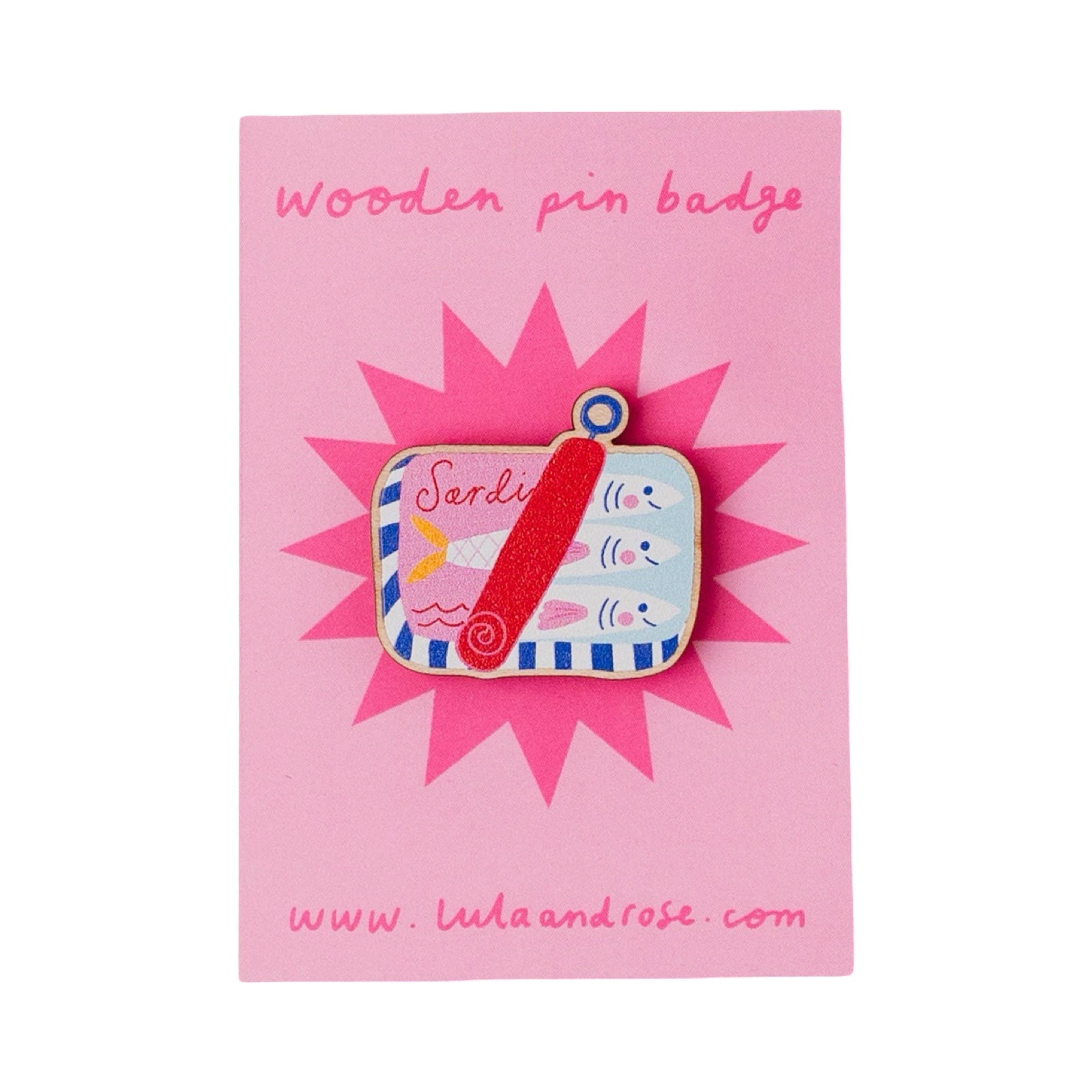 A wooden pin badge featuring a colourful illustration of a red sailboat on a blue and white striped background, mounted on a pink backing card with the text 'wooden pin badge'.