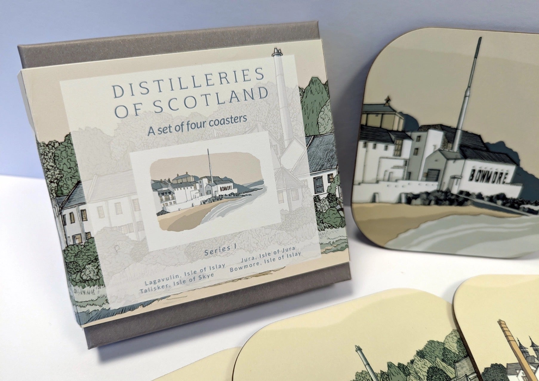 Set of four coasters with illustrations of Scottish distilleries, including a box packaging.