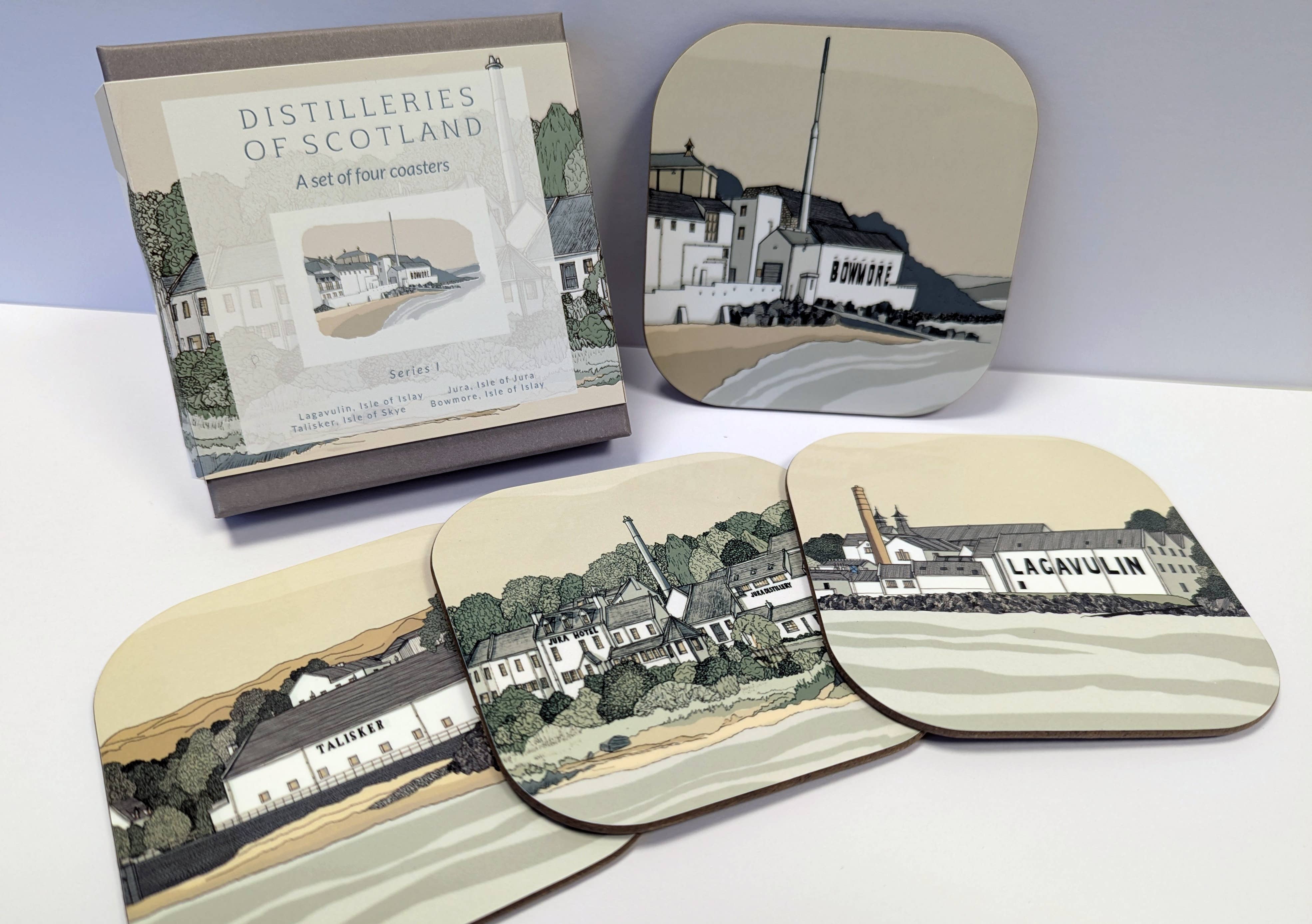 Set of coasters with Scottish distillery designs with a box on a white surface.