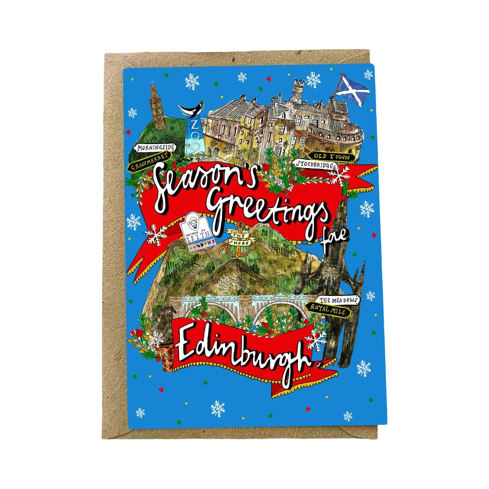 An illustrated greeting card with a brown kraft envelope behind it. The card has a bright blue background and features a whimsical winter map-style illustration of Edinburgh with red banners reading 'Season's Greetings' and 'Edinburgh'.