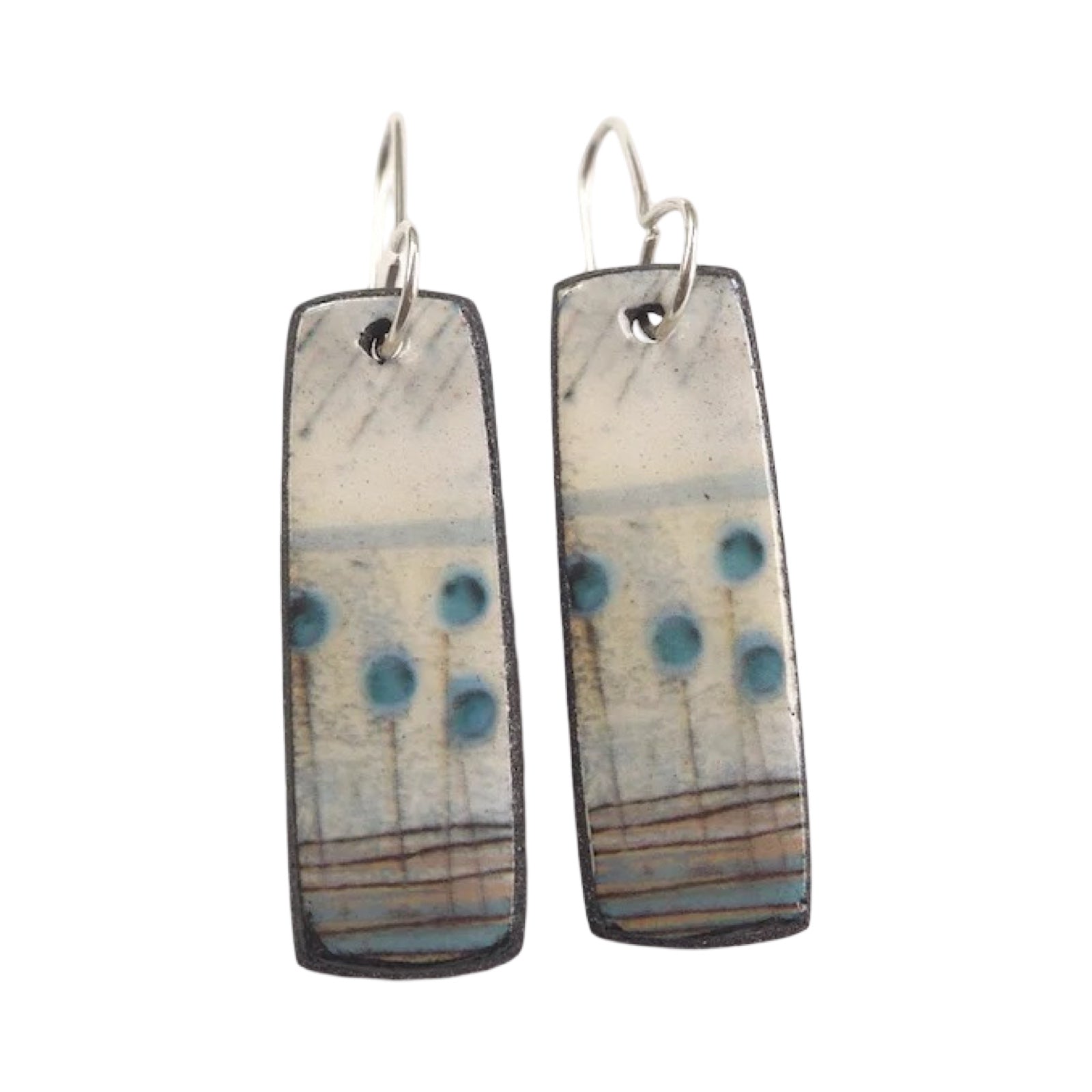 These porcelain drop earrings are made from black porcelain casting slip layered with a white decorating slip and a ceramic decal.