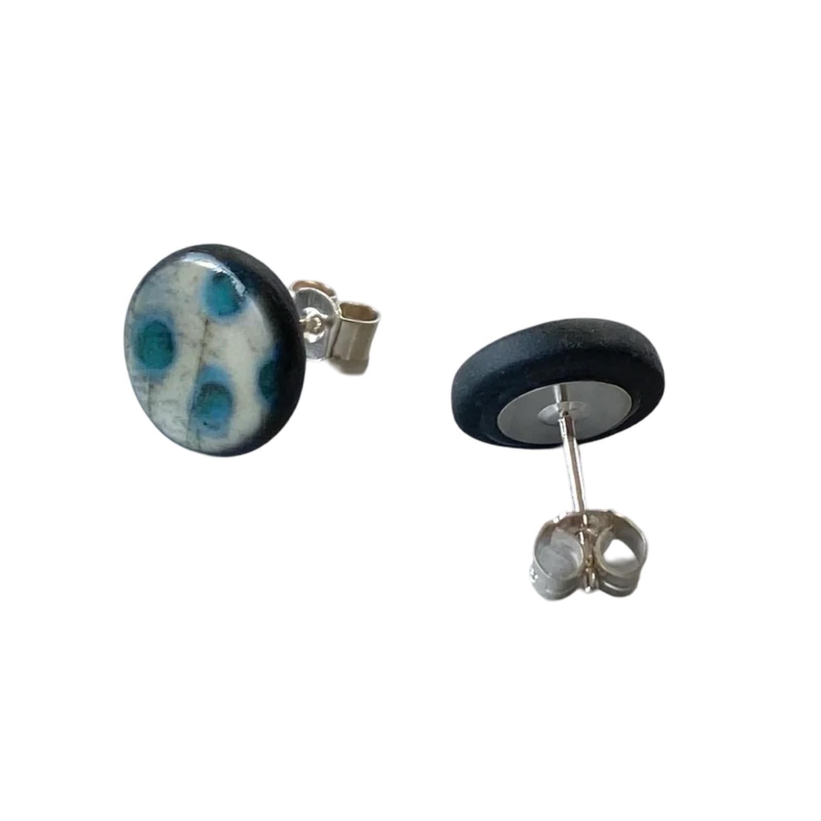These porcelain round stud earrings are made from black porcelain casting slip layered with a white decorating slip and a ceramic decal.