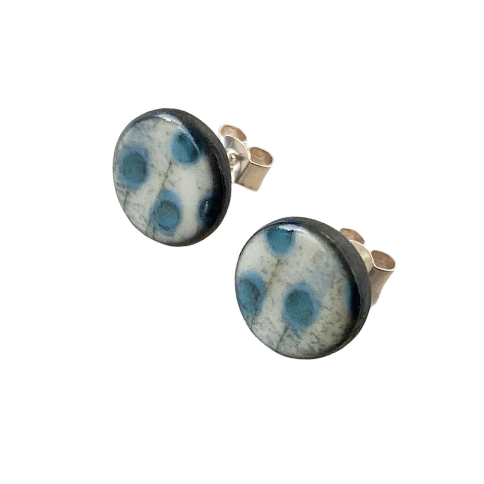 These porcelain round stud earrings are made from black porcelain casting slip layered with a white decorating slip and a ceramic decal.