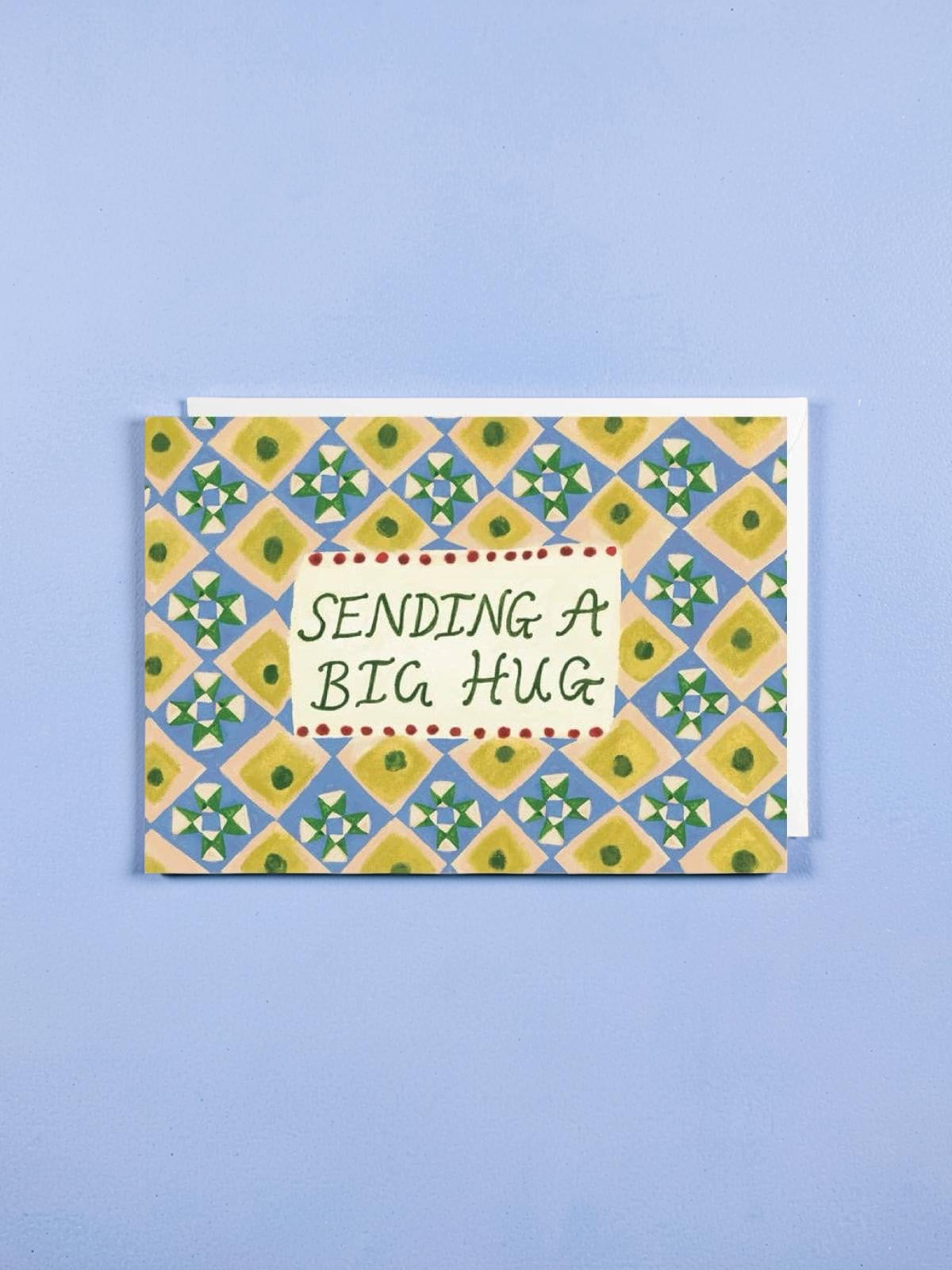 Greeting card with geometric pattern and 'Sending a Big Hug' text on a blue background.