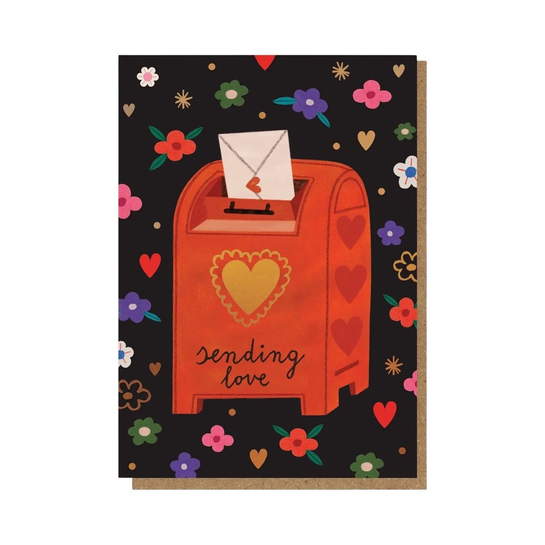 Love and friendship card featuring a letter being posted in a red post box with a gold love heart and the text ‘Sending love’.