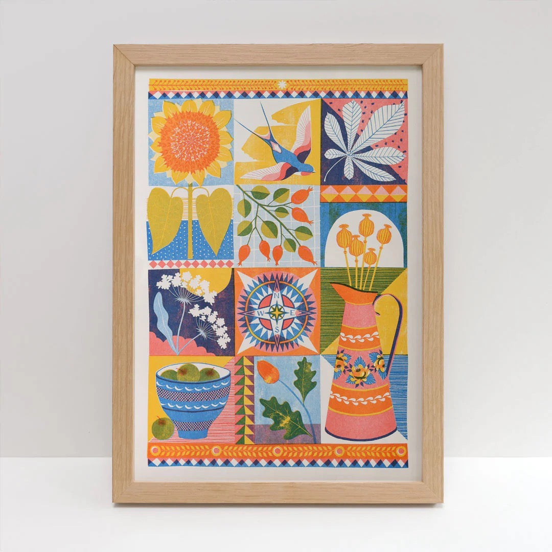 Framed colourful abstract art print on a white wall.