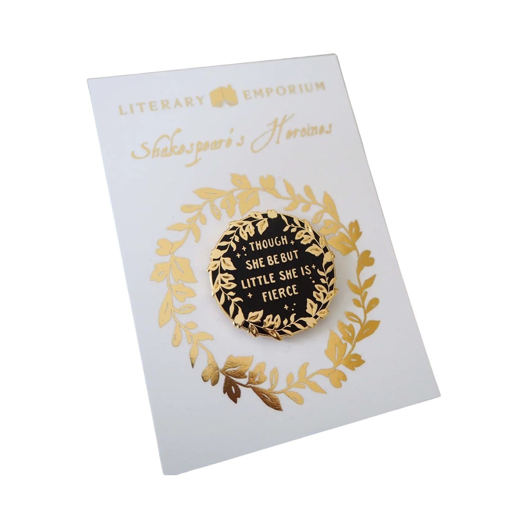 Circular enamel pin badge in black with gold foliage around the edges with the text 'And though she be but little, she is fierce' in gold in the centre. 